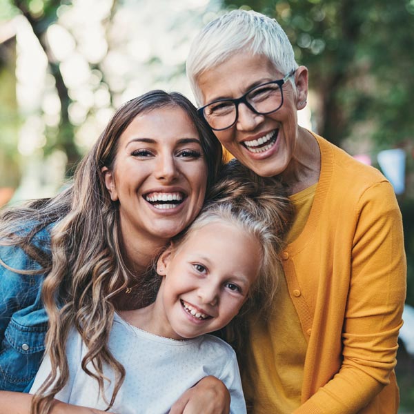 woman with mother and daughter smiling