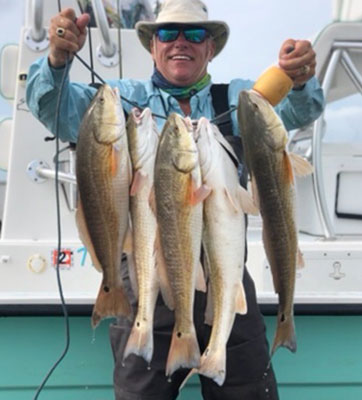 Dr. Perkins holding fish